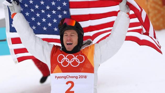 Shaun White of the U.S. celebrates his win as he holds the U.S. flag.(REUTERS)