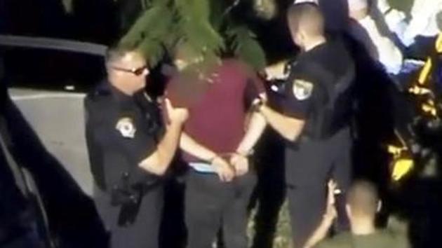 A man placed in handcuffs is led by police near Marjory Stoneman Douglas High School following a shooting incident in Parkland, Florida. (Reuters) A man placed in handcuffs is led by police near Marjory Stoneman Douglas High School following a shooting incident in Parkland, Florida. (Reuters)
