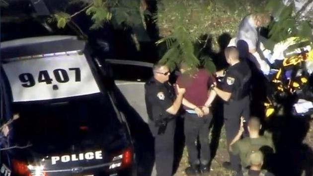 A man placed in handcuffs is led by police near Marjory Stoneman Douglas High School following a shooting incident in Parkland, Florida. (Reuters) A man placed in handcuffs is led by police near Marjory Stoneman Douglas High School following a shooting incident in Parkland, Florida. (Reuters)