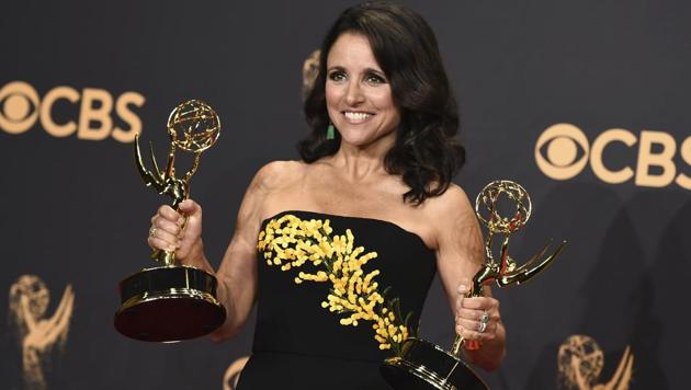 Julia Louis-Dreyfus poses in the press room with her awards for outstanding lead actress in a comedy series and outstanding comedy series for Veep at the 69th Primetime Emmy Awards at the Microsoft Theater in Los Angeles.(Jordan Strauss/Invision/AP)