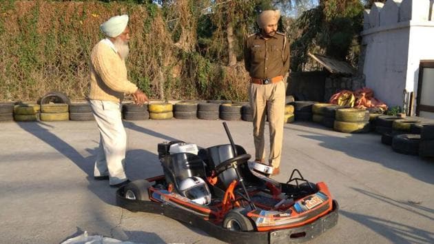 Police inspecting the go-kart in which Puneet Kaur’s hair got stuck at Aqua Village in Pinjore.(Sant Arora/HT)