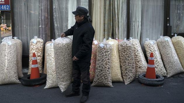A man lines up large bags of popped grains at his stall in the market. Such markets are a common sight across South Korea and popular among housewives. Local farmers bring fresh vegetables and seasonal fruits here, and stores sell kimchi, special snacks or other knick-knacks at prices much cheaper than stores. (Felipe Dana / AP) A man lines up large bags of popped grains at his stall in the market. Such markets are a common sight across South Korea and popular among housewives. Local farmers bring fresh vegetables and seasonal fruits here, and stores sell kimchi, special snacks or other knick-knacks at prices much cheaper than stores. (Felipe Dana / AP)