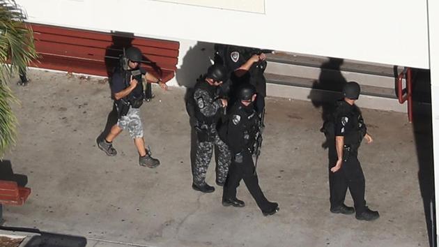 Law enforcement personel work the scene at the Marjory Stoneman Douglas High School after the shooting. Cruz set off the fire alarm to draw students into the hallway and waited for them at the entrance with the semi-automatic gun. (Joe Raedle / Getty Images / AFP) 