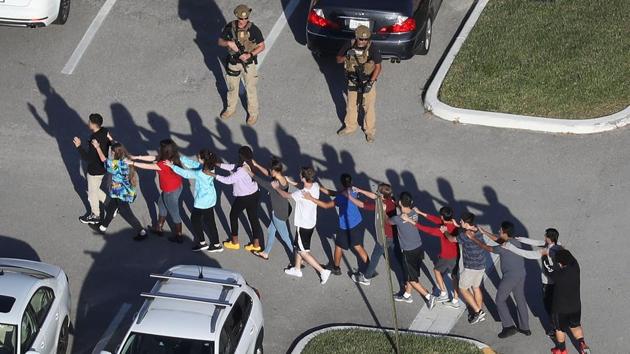 People are brought out of the Marjory Stoneman Douglas High School after a shooting in Parkland, Florida. (AFP Photo) People are brought out of the Marjory Stoneman Douglas High School after a shooting in Parkland, Florida. (AFP Photo)