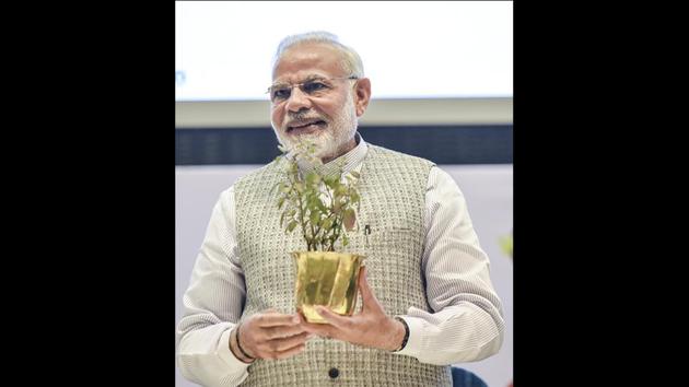 PM Narendra Modi holds a tulsi plant given to him during the inauguration function of World Sustainable Development Summit at Vigyan Bhawan in New Delhi. (Vipin Kumar / HT Photo) PM Narendra Modi holds a tulsi plant given to him during the inauguration function of World Sustainable Development Summit at Vigyan Bhawan in New Delhi. (Vipin Kumar / HT Photo)