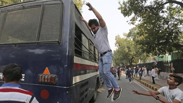 An activist of Congress party's youth wing jumps from the roof of a police bus after being detained during a protest against the Bharatiya Janata Party in New Delhi. The protestors were reacting to reports of an alleged Rs 11,400-crore fraud case by Nirav Modi at a Mumbai branch of the Punjab National Bank. (Altaf Qadri / AP) An activist of Congress party's youth wing jumps from the roof of a police bus after being detained during a protest against the Bharatiya Janata Party in New Delhi. The protestors were reacting to reports of an alleged Rs 11,400-crore fraud case by Nirav Modi at a Mumbai branch of the Punjab National Bank. (Altaf Qadri / AP)