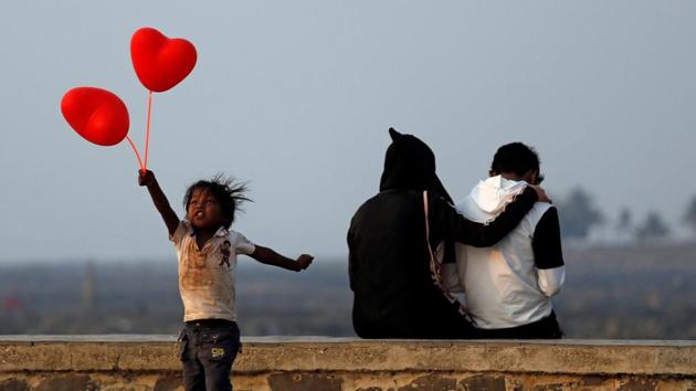 A child jumps from a promenade after attempting to sell heart-shaped balloons to a couple on Valentine's Day in Mumbai on February 14. (Francis Mascarenhas / REUTERS) A child jumps from a promenade after attempting to sell heart-shaped balloons to a couple on Valentine's Day in Mumbai on February 14. (Francis Mascarenhas / REUTERS)