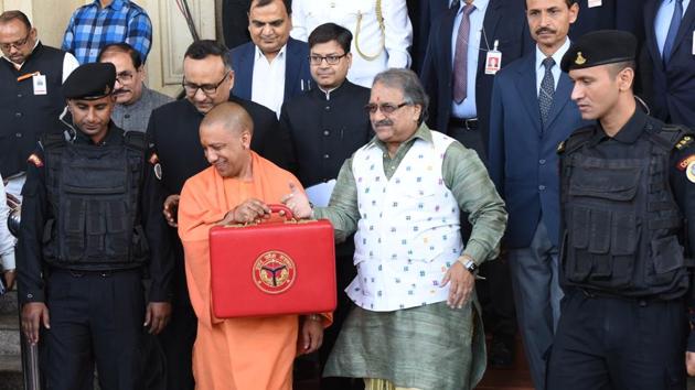 Uttar Pradesh chief minister Yogi Adityanath along with finance minister Rajesh Agarwal shows a red briefcase to present the state budget for 2018-19, outside the Assembly House, in Lucknow. (Subhankar Chakraborty / HT Photo) Uttar Pradesh chief minister Yogi Adityanath along with finance minister Rajesh Agarwal shows a red briefcase to present the state budget for 2018-19, outside the Assembly House, in Lucknow. (Subhankar Chakraborty / HT Photo)