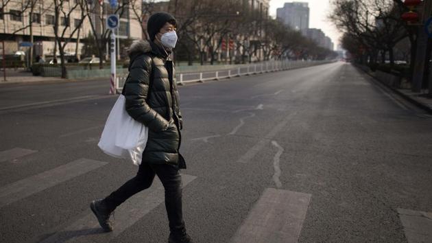 A man walks on an empty street in the centre of Beijing on February 15, 2018, ahead of the coming Lunar New Year, marking the year of the dog.(AFP Photo)