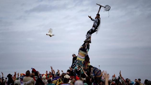 A reveller releases a chicken from a cage after climbing a greased pole during the Faquetaique Courir de Mardi Gras celebration in Eunice, Louisiana. (Jonathan Bachman / REUTERS) A reveller releases a chicken from a cage after climbing a greased pole during the Faquetaique Courir de Mardi Gras celebration in Eunice, Louisiana. (Jonathan Bachman / REUTERS)