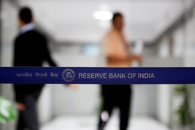 People walk past a barricade inside the Reserve Bank of India (RBI) headquarters in Mumbai on June 7, 2017.(REUTERS File)