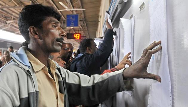 Passengers check the reservation chart at a railway station in Ludhiana.(HT File Photo)