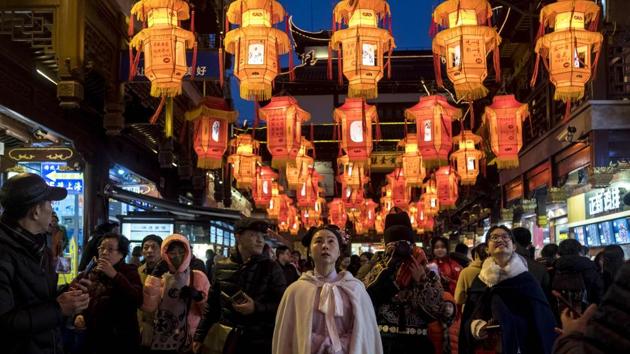 People walk past lantern decorations in Yu Yuan Garden in Shanghai ahead of the Lunar New year, marking the Year of the Dog. (Johannes Eisele / AFP) People walk past lantern decorations in Yu Yuan Garden in Shanghai ahead of the Lunar New year, marking the Year of the Dog. (Johannes Eisele / AFP)