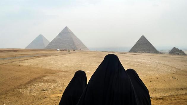 Women in veils look at the Great Pyramids of Giza from a vantage point across the Giza plateau, on the south-western outskirts of the Egyptian capital Cairo. (Khaled Desouki / AFP) Women in veils look at the Great Pyramids of Giza from a vantage point across the Giza plateau, on the south-western outskirts of the Egyptian capital Cairo. (Khaled Desouki / AFP)