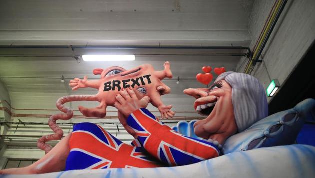 A carnival float, depicting Britain's Prime Minister Theresa May giving birth to the Brexit, is prepared at a warehouse ahead of a Rose Monday parade in Dusseldorf, Germany. (Marcel Kusch / dpa / AFP) A carnival float, depicting Britain's Prime Minister Theresa May giving birth to the Brexit, is prepared at a warehouse ahead of a Rose Monday parade in Dusseldorf, Germany. (Marcel Kusch / dpa / AFP)