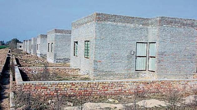 Two-room houses made for the poor by the HMEL, which runs the Bathinda refinery, in Kandu Khera village in Lambi segment represented by former CM Parkash Singh Badal; the houses lack finishing touches and are locked. (Sanjeev Kumar/HT) Two-room houses made for the poor by the HMEL, which runs the Bathinda refinery, in Kandu Khera village in Lambi segment represented by former CM Parkash Singh Badal; the houses lack finishing touches and are locked. (Sanjeev Kumar/HT)
