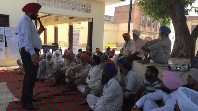 Dr Sukhcharan Gosal, former deputy director with the animal husbandry department, and now a master trainer with UDAY social enterprise project, addressing villagers near Sangrur. (HT Photo) Dr Sukhcharan Gosal, former deputy director with the animal husbandry department, and now a master trainer with UDAY social enterprise project, addressing villagers near Sangrur. (HT Photo)