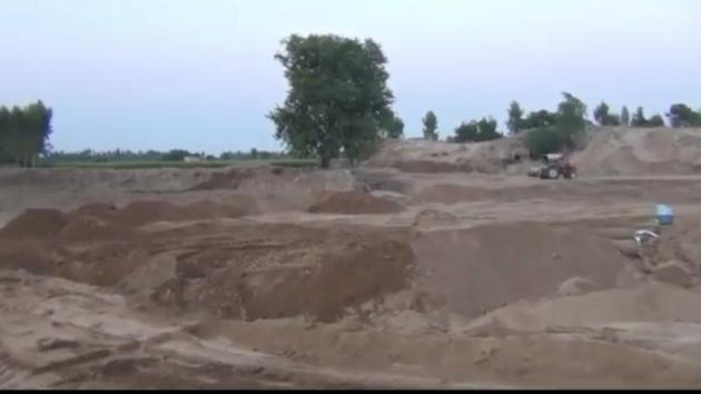 The adjoining cultivated land faces the threat of a massive cave-in, as has been reported by HT last month too. Local farmers say they fear the mafia who purportedly enjoy political patronage. (HT File) The adjoining cultivated land faces the threat of a massive cave-in, as has been reported by HT last month too. Local farmers say they fear the mafia who purportedly enjoy political patronage. (HT File)