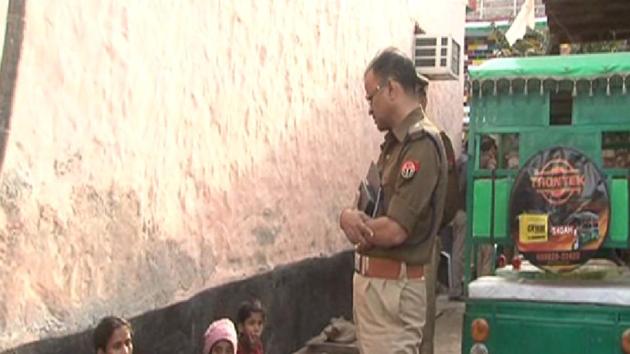 A policeman talks to neighbours of the victim who alerted the police about the incident. A policeman talks to neighbours of the victim who alerted the police about the incident.