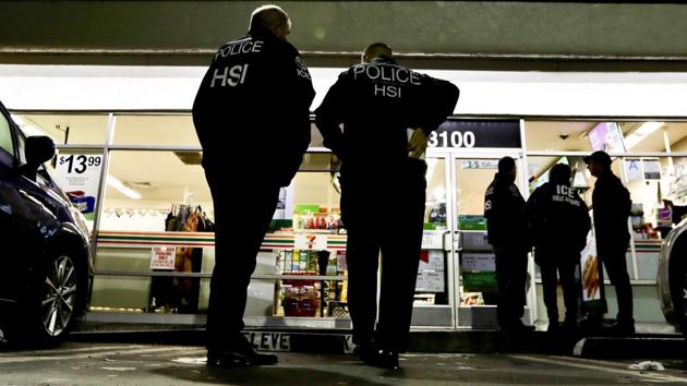US Immigration and Customs Enforcement agents serve an employment audit notice at a 7-Eleven convenience store in Los Angeles. (AP File Photo) US Immigration and Customs Enforcement agents serve an employment audit notice at a 7-Eleven convenience store in Los Angeles. (AP File Photo)