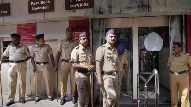 Police personnel stand guard outside a Punjab National Bank branch during NCP's protest against Nirav Modi in Thane on Saturday. (PTI Photo) Police personnel stand guard outside a Punjab National Bank branch during NCP's protest against Nirav Modi in Thane on Saturday. (PTI Photo)