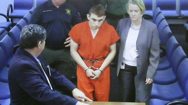 Hector Romero Assistant Public Defender (L) and Melisa McNeill, Public Defender (R) are seen on screen at the first appearance in court for high school shooting suspect Nikolas Cruz (C) on February 15, 2018 at Broward County Court House in Fort Lauderdale, Florida. (AFP) Hector Romero Assistant Public Defender (L) and Melisa McNeill, Public Defender (R) are seen on screen at the first appearance in court for high school shooting suspect Nikolas Cruz (C) on February 15, 2018 at Broward County Court House in Fort Lauderdale, Florida. (AFP)