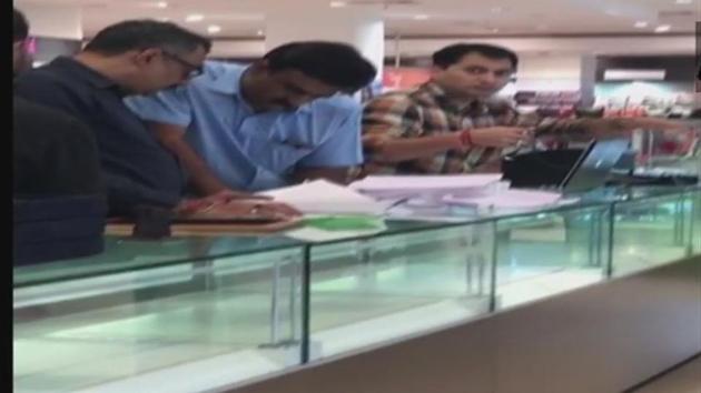 Enforcement Directorate officials conduct raids inside Shoppers Stop at Alpha One Mall in Ahmedabad.(ANI)