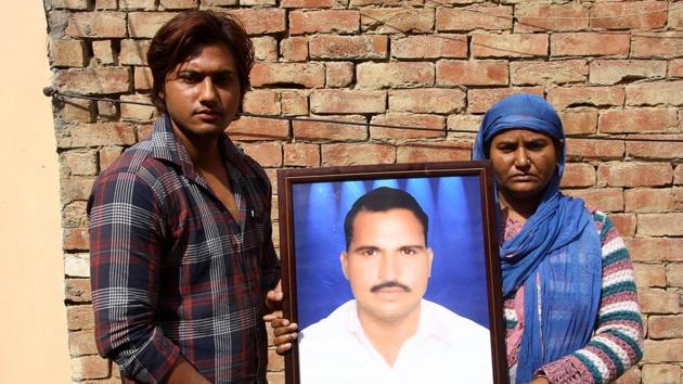 Bharti Saini and her son holding the photograph Shyam Saini, who was killed during the Jat stir, in Jhajjar on Saturday. (HT Photo) Bharti Saini and her son holding the photograph Shyam Saini, who was killed during the Jat stir, in Jhajjar on Saturday. (HT Photo)