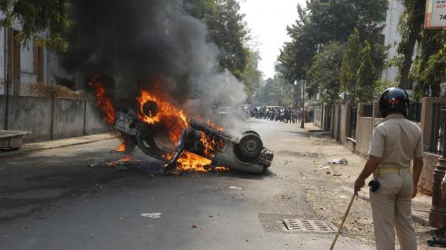 A car is set on fire by a mob during a protest in Ahmadabad on Sunday. (AP Photo) A car is set on fire by a mob during a protest in Ahmadabad on Sunday. (AP Photo)