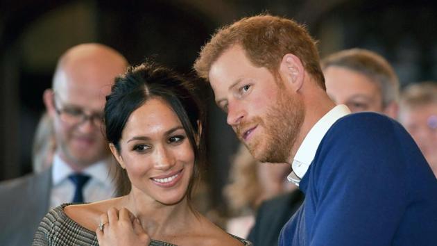 Britain's Prince Harry talks to Meghan Markle as they watch a dance performance by Jukebox Collective in the banqueting hall during a visit to Cardiff Castle, Wales. With Prince Harry and Meghan Markle's May 19 wedding fast approaching, the fashion and bridal worlds are abuzz with talk of who the bride will pick to design her dress and what kind of look she would go for. (AP) Britain's Prince Harry talks to Meghan Markle as they watch a dance performance by Jukebox Collective in the banqueting hall during a visit to Cardiff Castle, Wales. With Prince Harry and Meghan Markle's May 19 wedding fast approaching, the fashion and bridal worlds are abuzz with talk of who the bride will pick to design her dress and what kind of look she would go for. (AP)