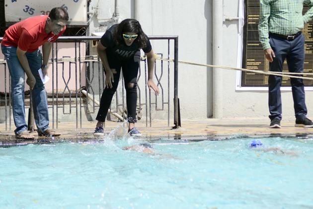 Parents cheer fort their children during the All India Invitation Swimathon, organised by Champion Aquatic Club at NG Nande swimming pool, on February 18. (Ravindra Joshi/HT PHOTO)