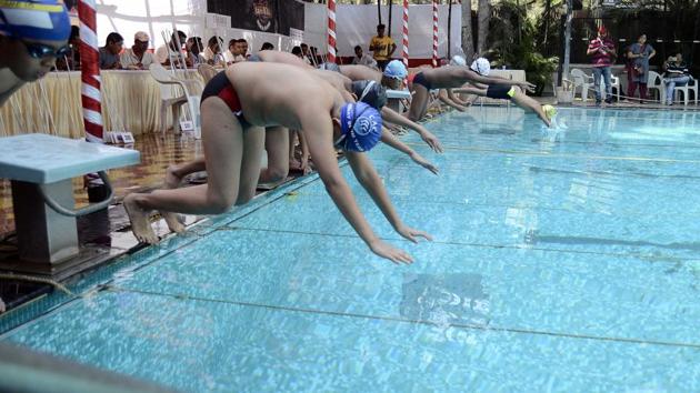 Participants dive into the swimming pool during the All India Invitation Swimathon, by Champion Aquatic Club at NG Nande swimming pool, February 18. (Ravindra Joshi/HT PHOTO)