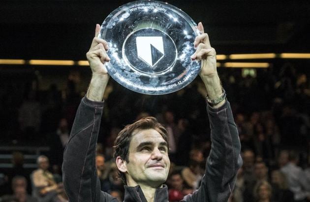 Roger Federer of Switzerland holds up the trophy as he celebrates winning his match against Bulgaria's Grigor Dimitrov in two sets, 6-2, 6-2, in the men's singles final of the ABN AMRO world tennis tournament at the Ahoy stadium in Rotterdam, Netherlands on Sunday.(AP)