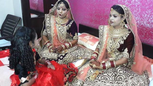 (Left to right) Sarita and Rajni in their bridal finery before the wedding in Tonk on Tuesday.(HT Photp)