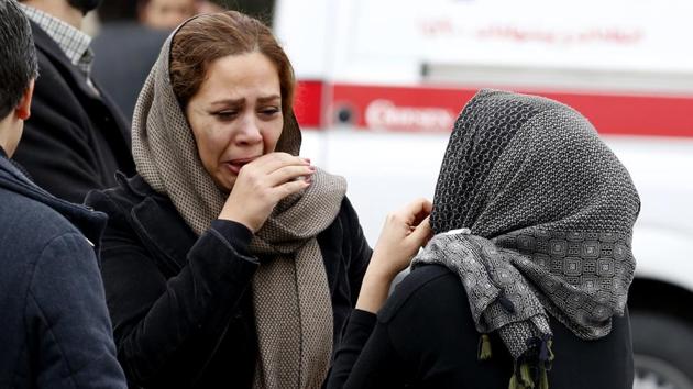 Relatives of Iranian passengers, onboard the Aseman Airlines flight EP3704, in a helpless wait, now entering the third day since the crash.  (Atta Kenare / AFP) 