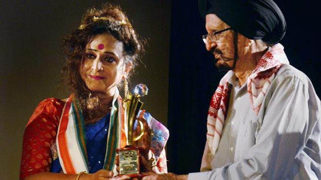 India's first transgender college principal Manabi Bandopadhyay receives National Woman Empowerment Award 2018 from veteran hockey player Gurubox Singh at an event organized by National Intregation Forum in Kolkata on late Monday. (PTI)