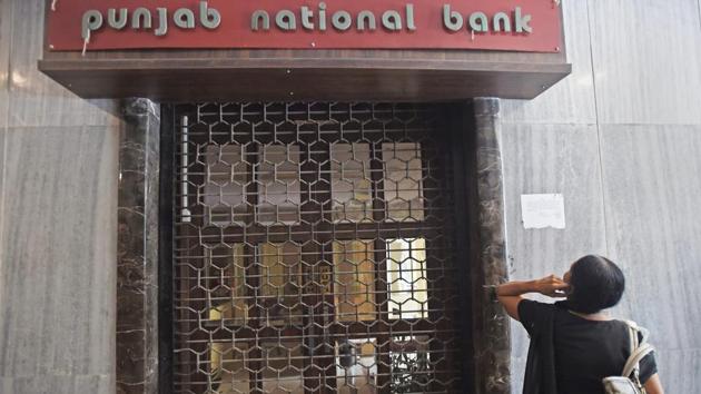 A woman in front of Punjab National Bank’s Brady House branch in South Mumbai that was sealed on Monday. (PTI Photo) A woman in front of Punjab National Bank’s Brady House branch in South Mumbai that was sealed on Monday. (PTI Photo)