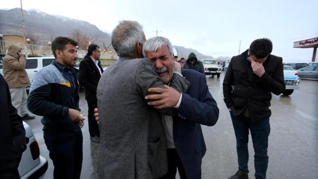 Relatives of passengers who are believed to have been killed in the plane crash near the town of Semirom, Iran. According to the IRNA news agency, families of the passengers had travelled to the area and were giving DNA sample kits for later identification of victims. (Tasnim News Agency / REUTERS) 