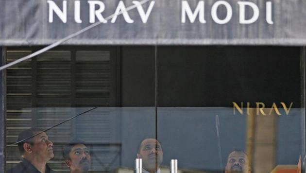 Security guards stand inside a Nirav Modi showroom during a raid by the Enforcement Directorate in New Delhi on February 15, 2018.(Reuters Photo) Security guards stand inside a Nirav Modi showroom during a raid by the Enforcement Directorate in New Delhi on February 15, 2018.(Reuters Photo)