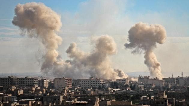 Smoke rises from buildings following bombardment on the village of Mesraba in the rebel-held besieged region of Eastern Ghouta on the outskirts of the capital Damascus. According to the Syrian Observatory for Human Rights (SOHR), at least 250 civilians have been killed by shelling and air strikes in last two days. (Hamza Al-Ajweh / AFP)