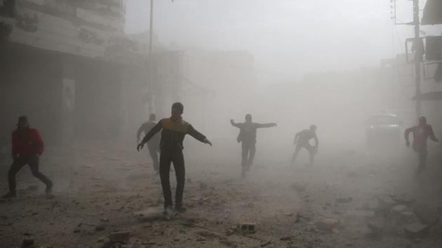 Civil defence members and civilians are seen running after an air raid, outside of Damascus. The bloodshed prompted the UN children’s agency UNICEF to issue a largely blank statement on Tuesday saying “we no longer have the words to describe children’s suffering.” (Bassam Khabieh / REUTERS)