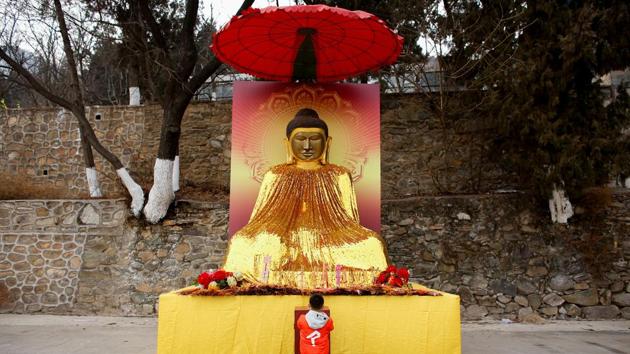 A boy prays at a Buddhist temple in Badachu park during Spring Festival celebrations marking Chinese New Year in Beijing on February 17.(Reuters File Photo) A boy prays at a Buddhist temple in Badachu park during Spring Festival celebrations marking Chinese New Year in Beijing on February 17.(Reuters File Photo)