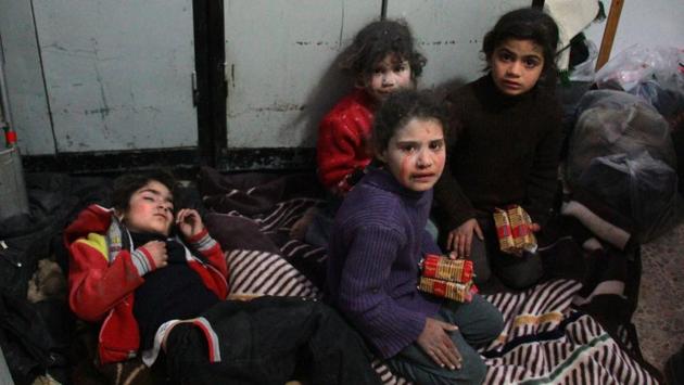 Syrian children seen at a makeshift hospital in Douma following air strikes on the Syrian village of Mesraba. Doctors have been working round the clock to treat hundreds of injured people, even though medical supplies and facilities were in short supply. (Hamza Al-Ajweh / AFP)