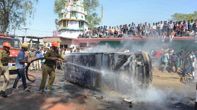 Firemen attempt to douse a fire in a police van, set by an angry mob following a incident in which a speeding truck rammed into a house and a shop at Barela in Jabalpur. (PTI) Firemen attempt to douse a fire in a police van, set by an angry mob following a incident in which a speeding truck rammed into a house and a shop at Barela in Jabalpur. (PTI)
