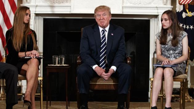 US President Donald Trump, joined by Marjory Stoneman Douglas High School student Carson Abt (R) and Julia Cordover, the student body president at Marjory Stoneman Douglas High School, during a listening session with high school students, teachers and others in the State Dining Room of the White House in Washington, on Wednesday. (AP Phot) US President Donald Trump, joined by Marjory Stoneman Douglas High School student Carson Abt (R) and Julia Cordover, the student body president at Marjory Stoneman Douglas High School, during a listening session with high school students, teachers and others in the State Dining Room of the White House in Washington, on Wednesday. (AP Phot)