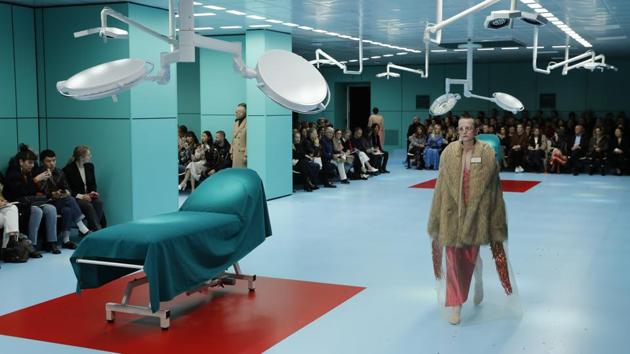 The first shock was when it started on time - almost unprecedented in fashion history. Men and women walked on the runway amid operating tables under bright neon lights in the Gucci Hub, the brand’s Milan headquarters, over the steady beeping of a heart monitoring machine. (Antonio Calanni / AP)