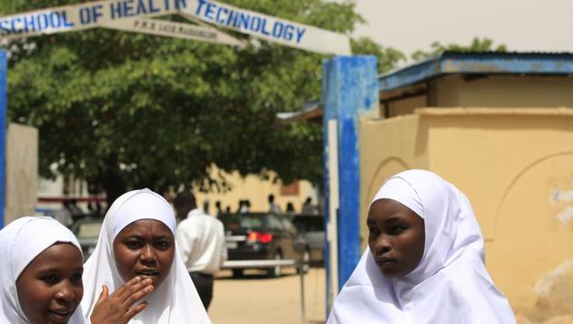 File photo of girls standing in front of a school in Maiduguri, Nigeria. About 100 young women remain missing as of February 21 after Boko Haram extremists attacked a town in northeast Nigeria. (AP Photo) File photo of girls standing in front of a school in Maiduguri, Nigeria. About 100 young women remain missing as of February 21 after Boko Haram extremists attacked a town in northeast Nigeria. (AP Photo)