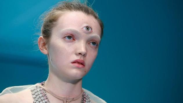The models added to the transgressive vibe -- not only did some carry replicas of their own severed head, but others were adorned with a third eye, or even a baby dragon. (Tony Gentile / REUTERS)
