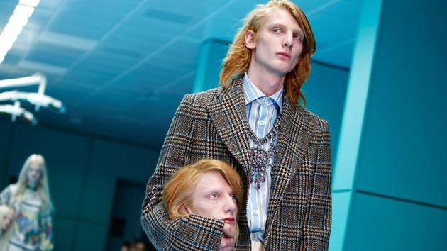 Gucci kicked off Milan Fashion Week in an eccentric style as models carried severed replicas of their own heads on a runway transformed into a creepy operating room. (Tony Gentile / REUTERS) Gucci kicked off Milan Fashion Week in an eccentric style as models carried severed replicas of their own heads on a runway transformed into a creepy operating room. (Tony Gentile / REUTERS)