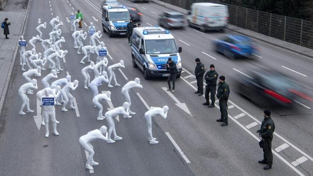 Greenpeace activists wear white morphsuits as they stage action against particulate matter and health burden caused by diesel exhaust in Germany on February 19. (Sebastian Gollnow / dpa / Germany Out / AFP) Greenpeace activists wear white morphsuits as they stage action against particulate matter and health burden caused by diesel exhaust in Germany on February 19. (Sebastian Gollnow / dpa / Germany Out / AFP)